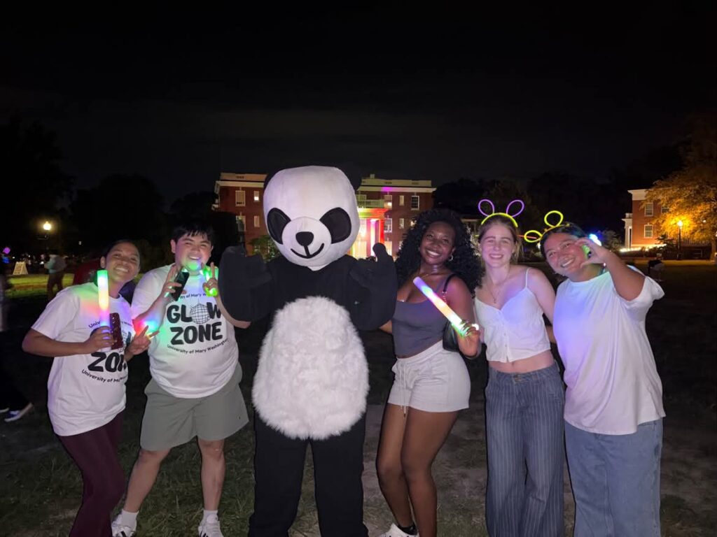 5 students and a panda with glow sticks